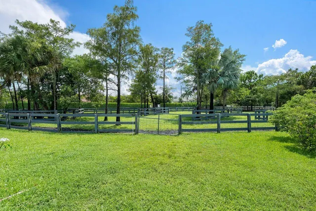 an aerial view of a swimming pool a yard and outdoor seating