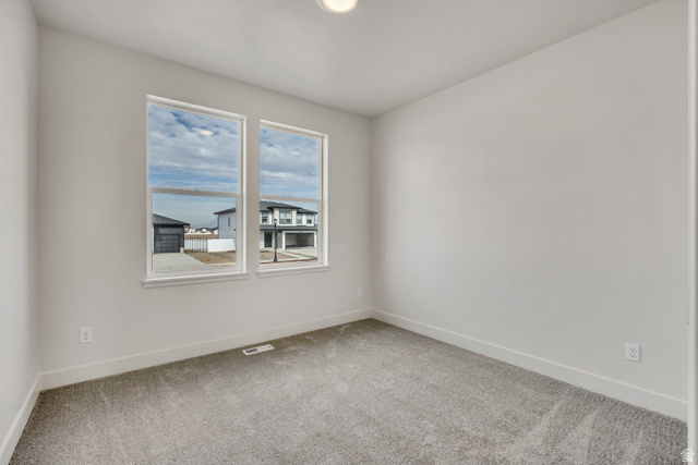 3839 West 825 North, Unit WF18 West Point, UT 84015 - Photo 17 of 22 Spare room featuring baseboards and light colored carpet