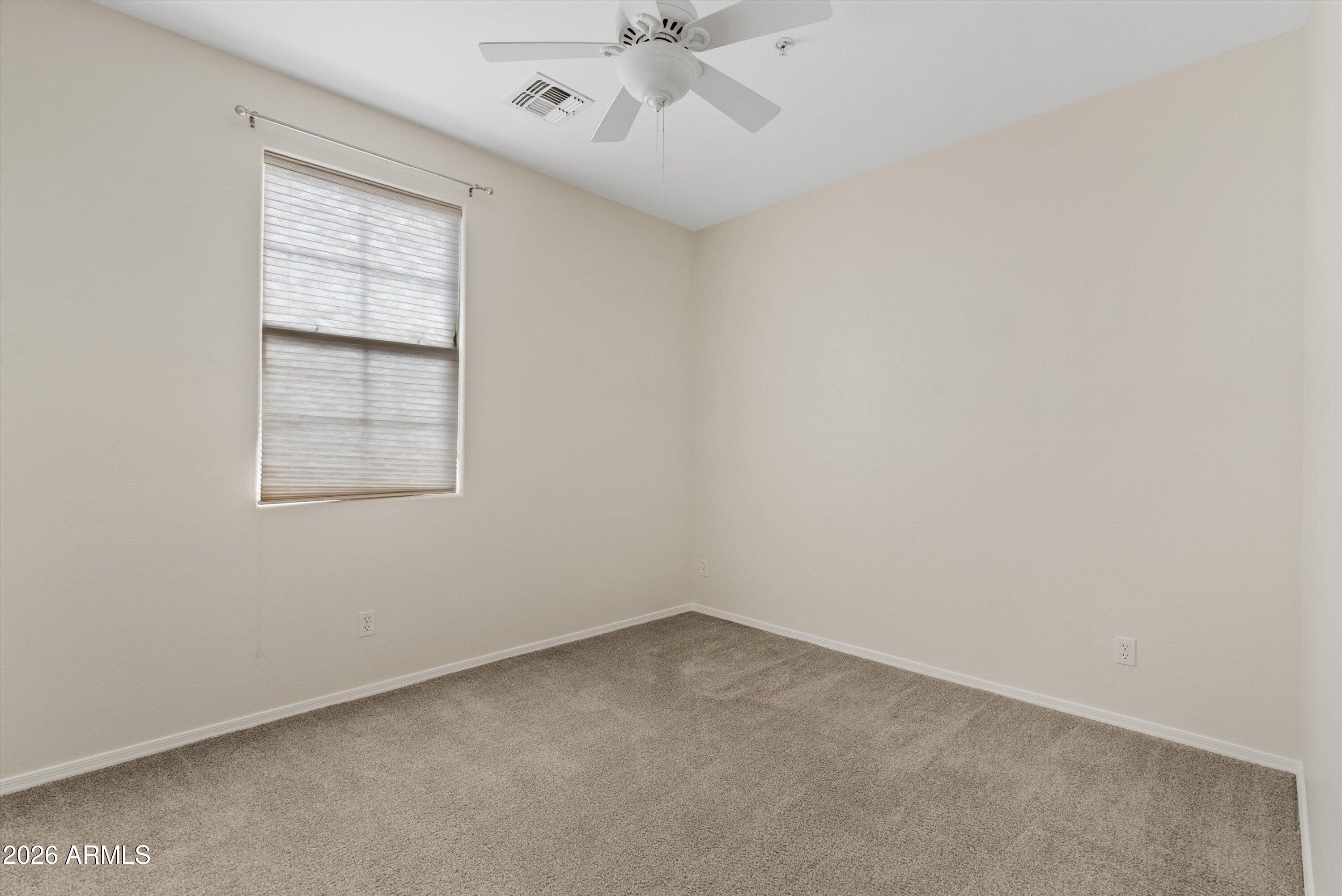 1265 South Aaron, Unit 245 Mesa, AZ 85209 - Photo 12 of 30 an empty room with a window and a fan