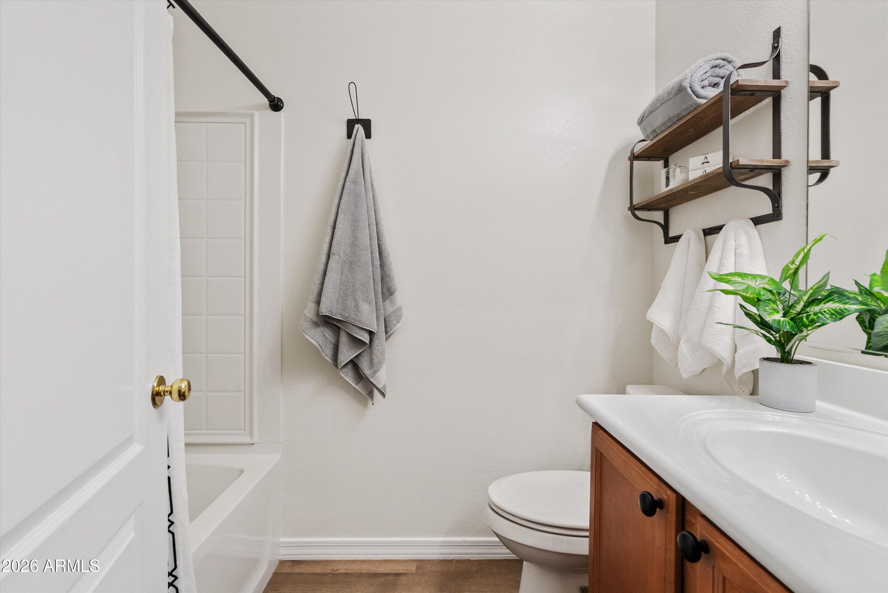 1265 South Aaron, Unit 245 Mesa, AZ 85209 - Photo 14 of 30 a bathroom with a sink a toilet and shower