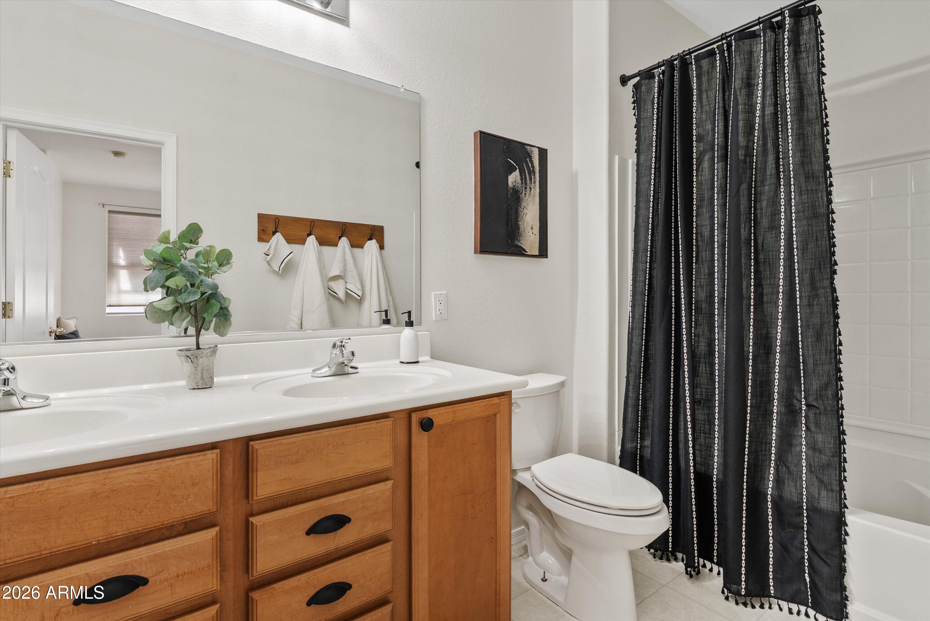 1265 South Aaron, Unit 245 Mesa, AZ 85209 - Photo 19 of 30 a bathroom with a sink a toilet and mirror