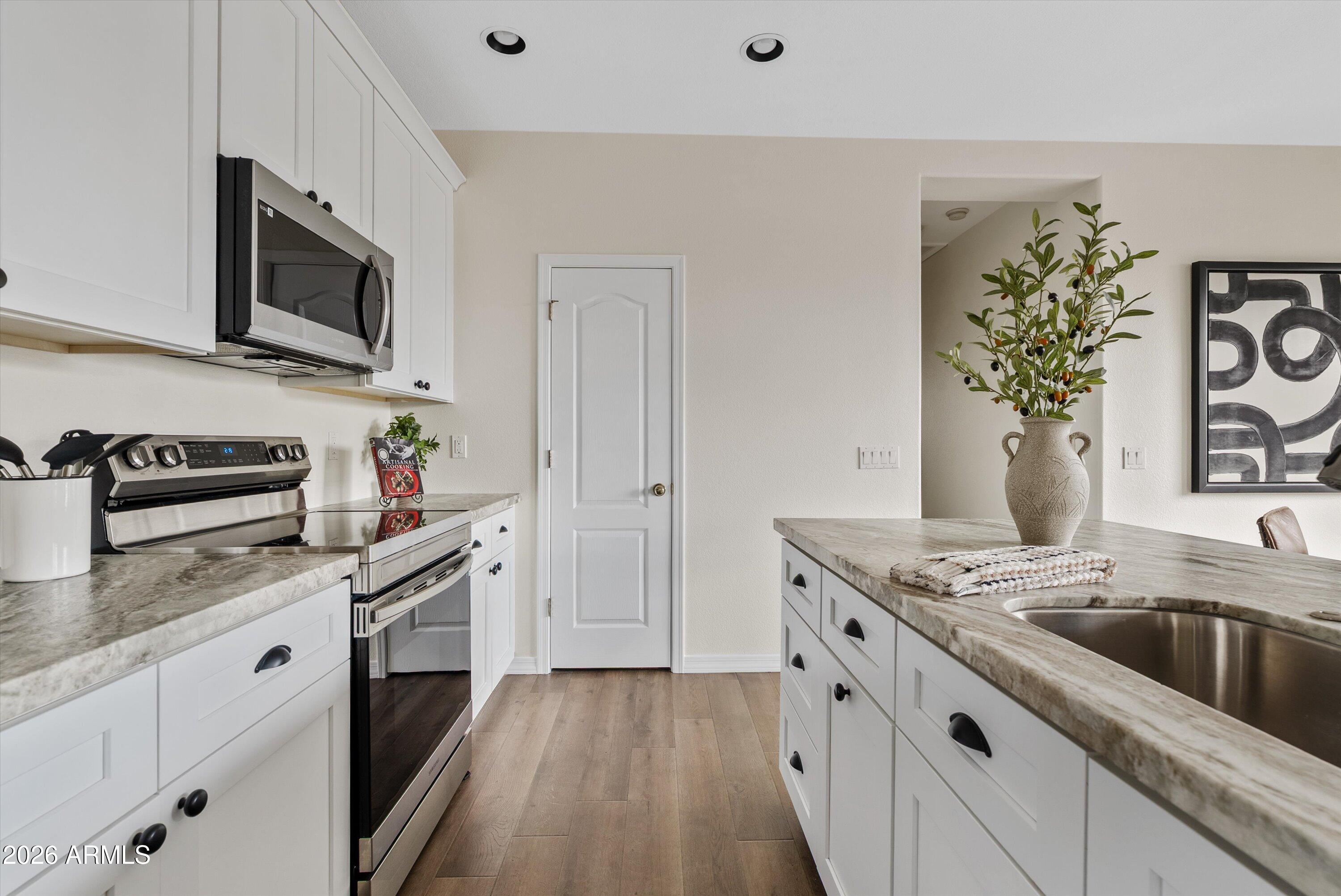 1265 South Aaron, Unit 245 Mesa, AZ 85209 - Photo 7 of 30 a kitchen with a sink stove and microwave