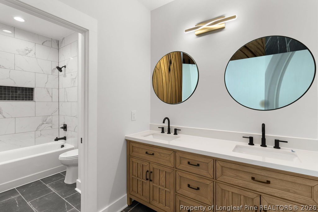 408 Stable Court Linden, NC 28356 - Photo 17 of 29 a bathroom with a double vanity sink mirror and bathtub