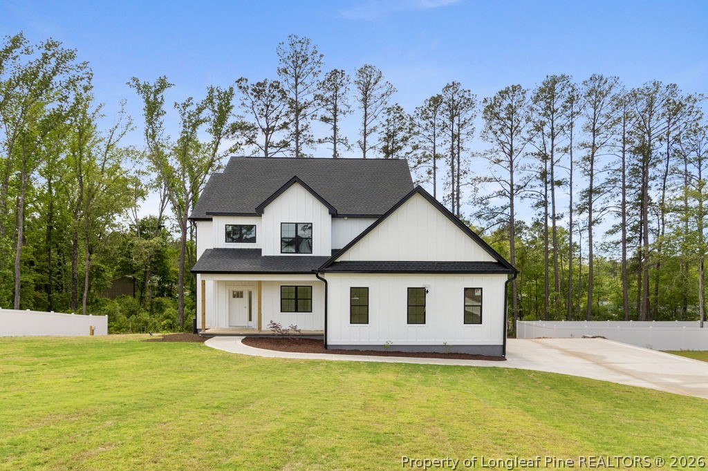408 Stable Court Linden, NC 28356 - Photo 2 of 29 a front view of a house with a garden and trees