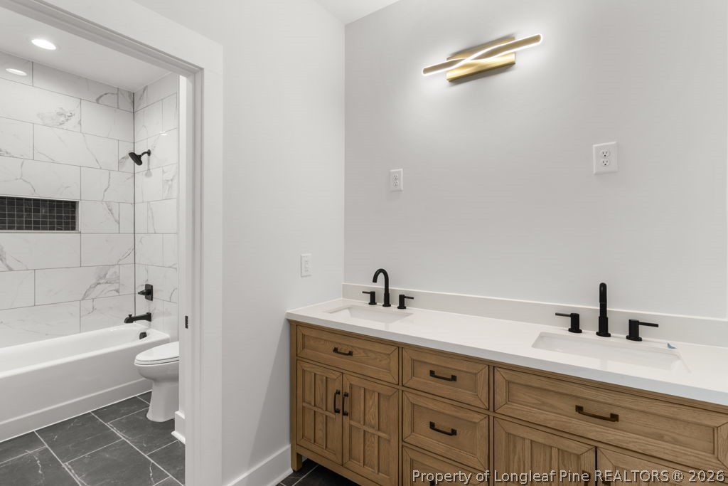 408 Stable Court Linden, NC 28356 - Photo 21 of 29 a bathroom with a tub sink toilet and a mirror