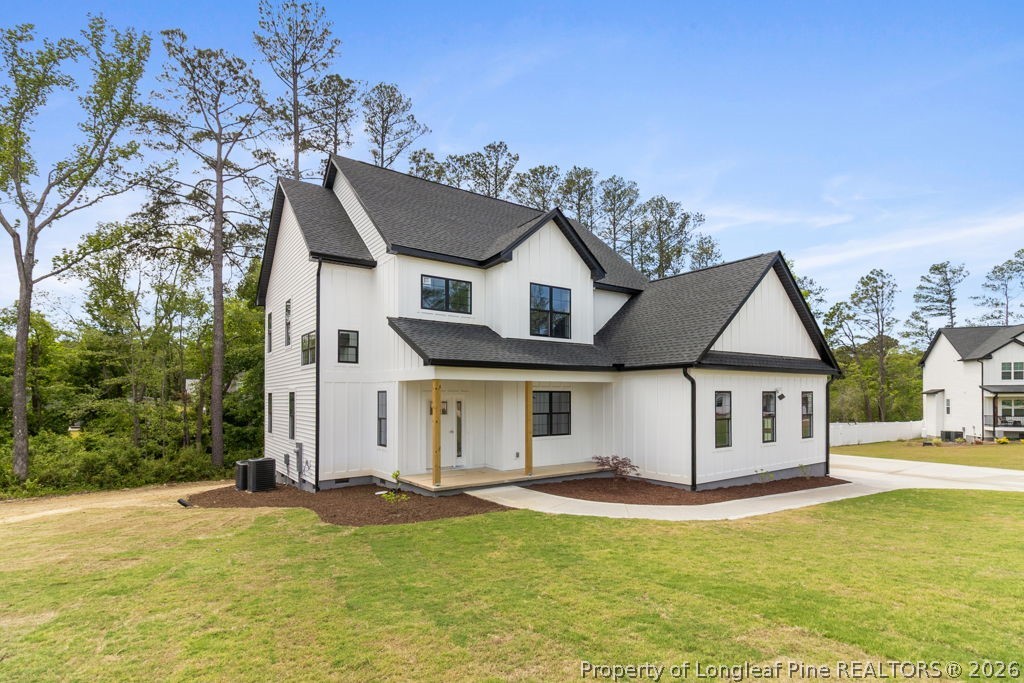 408 Stable Court Linden, NC 28356 - Photo 3 of 29 a view of a white house with a big yard and large trees