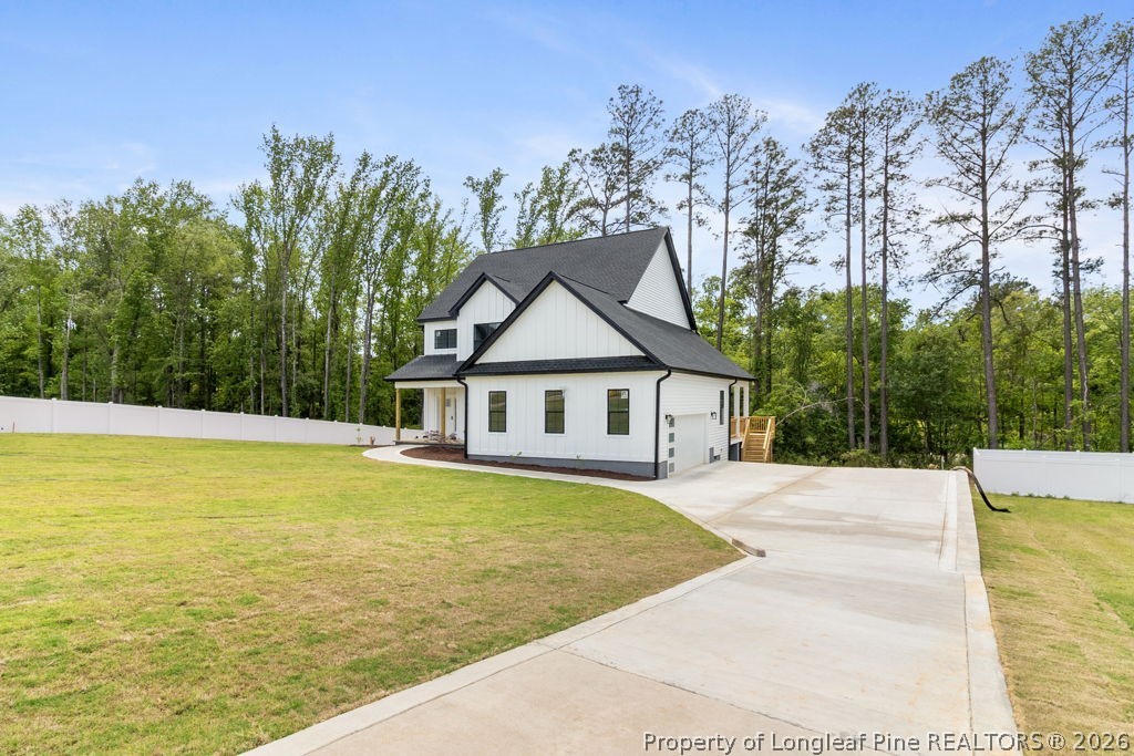 408 Stable Court Linden, NC 28356 - Photo 5 of 29 a view of house with outdoor space and trees around
