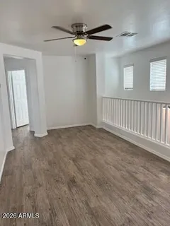 a view of an empty room with wooden floor