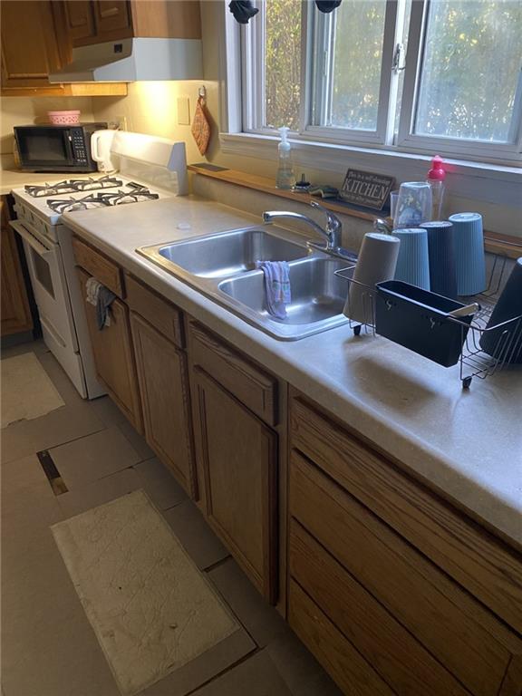 18 St John Street McKees Rocks, PA 15136 - Photo 13 of 20 a kitchen with a sink and a stove next to a window