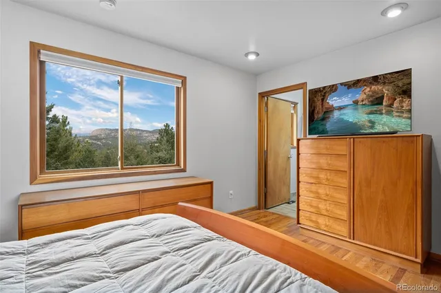 a bedroom with a bed and a flat screen tv