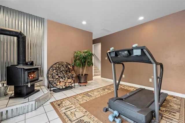 a room with gym equipment and view of living room