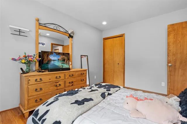 a bedroom with a bed and a dresser in it