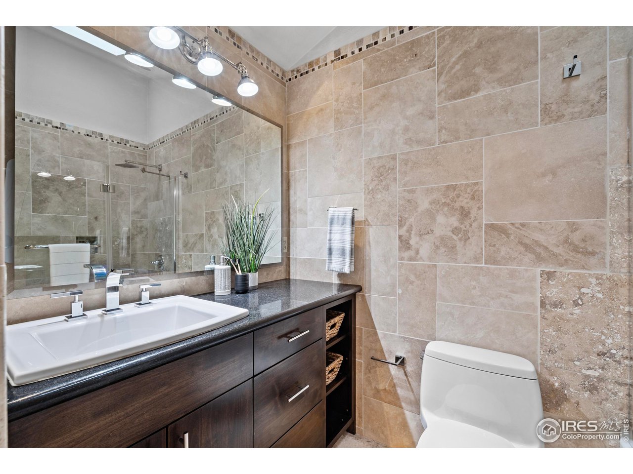 1601 West Swallow Road, Unit 8C Fort Collins, CO 80526 - Photo 17 of 36 a bathroom with a sink a mirror and a shower