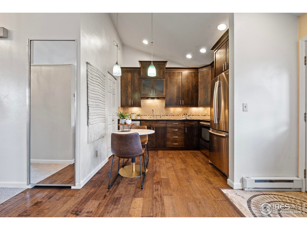 1601 West Swallow Road, Unit 8C Fort Collins, CO 80526 - Photo 10 of 36 a living room with stainless steel appliances kitchen island granite countertop furniture and a wooden floor