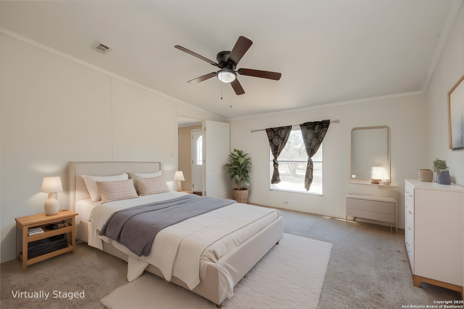 1007 County Road 773 Devine, TX 78016 - Photo 13 of 31 a spacious bedroom with a large bed and a chandelier