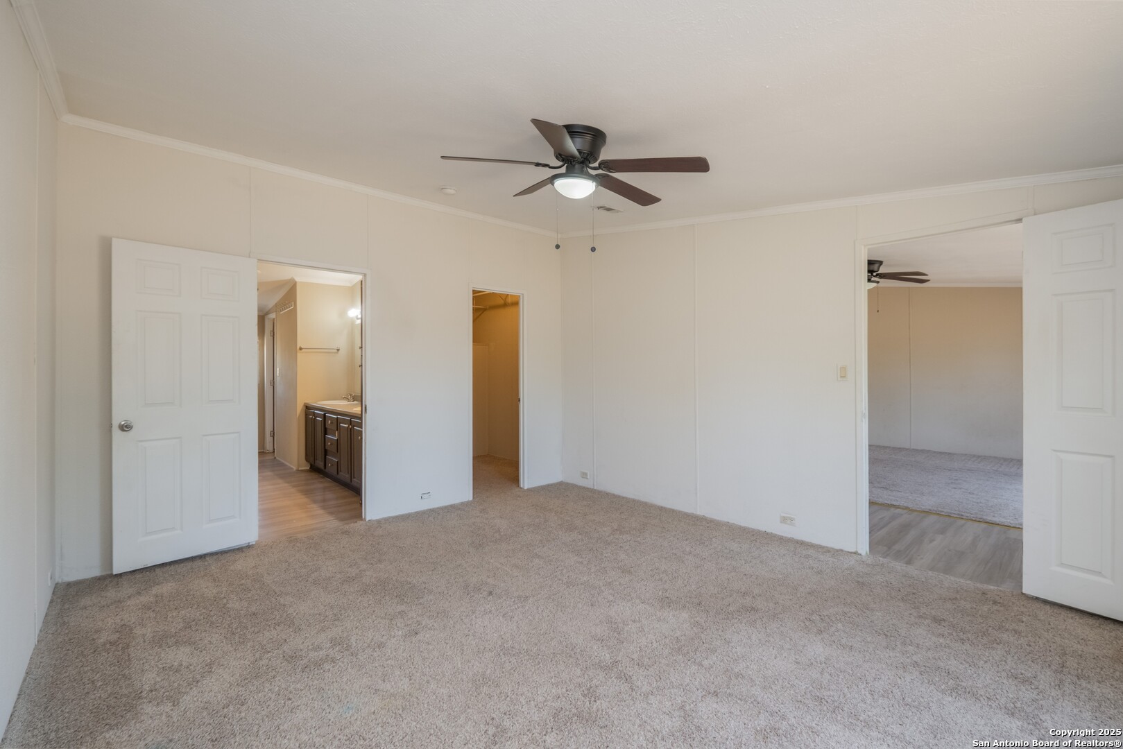 1007 County Road 773 Devine, TX 78016 - Photo 14 of 31 a view of a big room with closet and ceiling fan