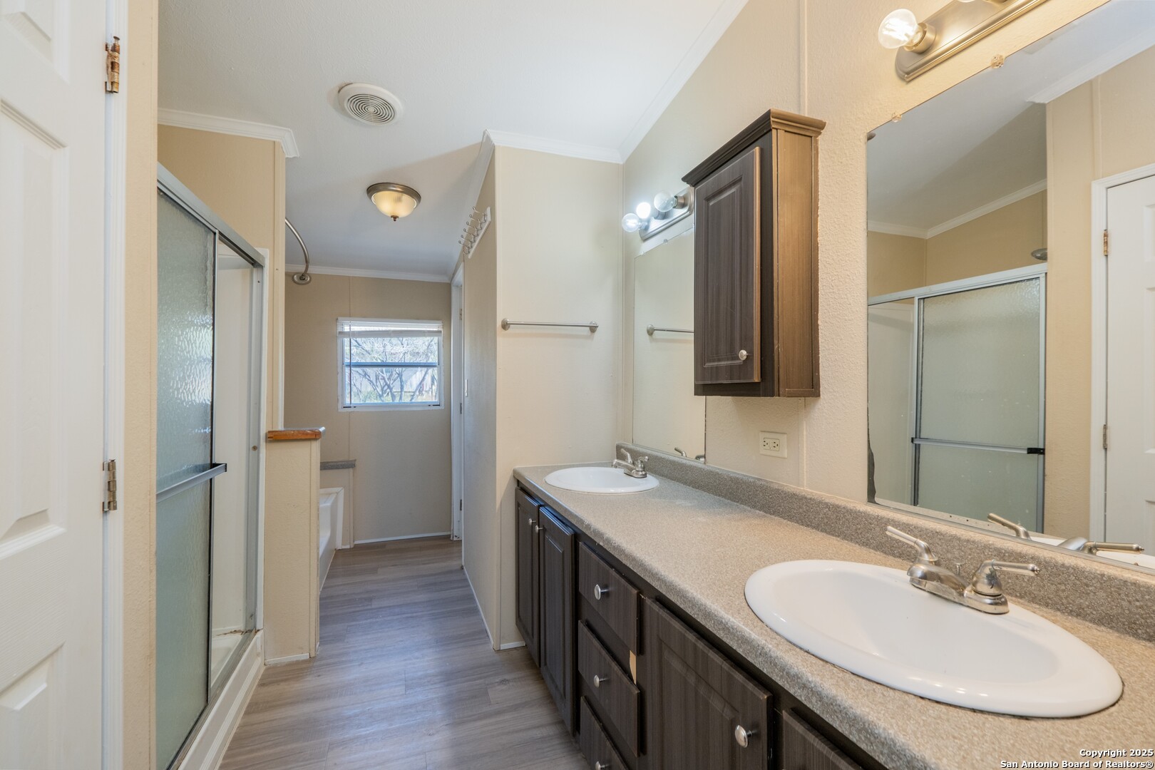 1007 County Road 773 Devine, TX 78016 - Photo 15 of 31 a bathroom with a double vanity sink and a mirror