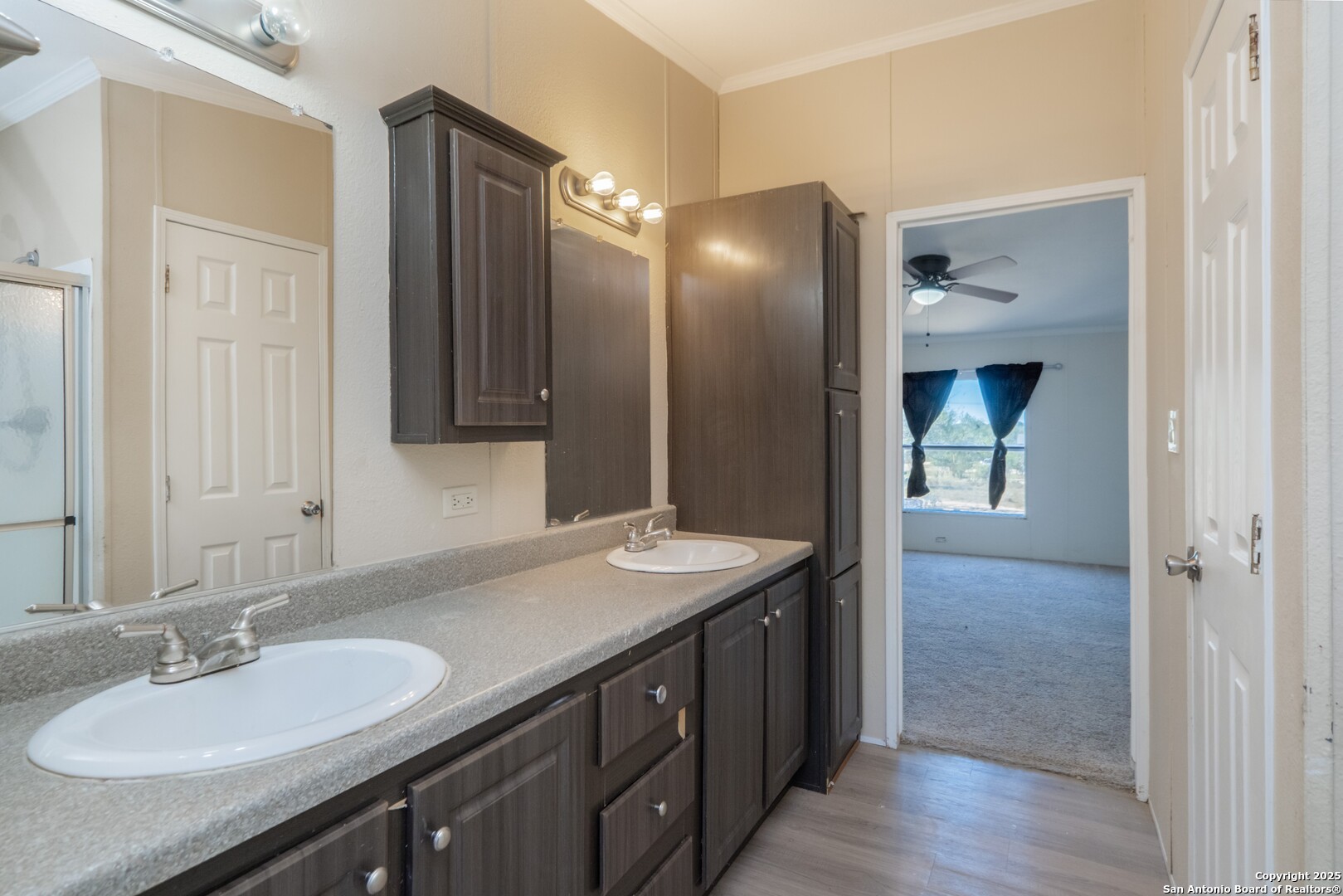 1007 County Road 773 Devine, TX 78016 - Photo 16 of 31 a bathroom with a sink and a mirror