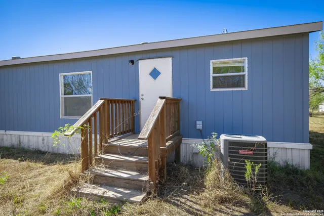 a view of backyard with wooden fence
