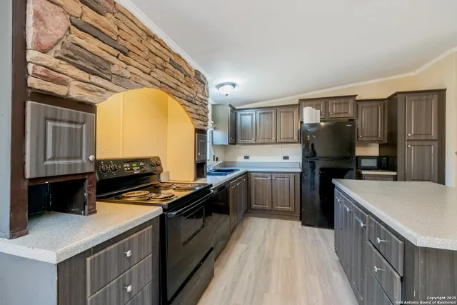 a kitchen with a stove a sink and a refrigerator