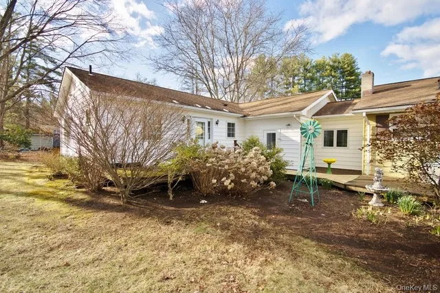 a backyard of a house with table and chairs