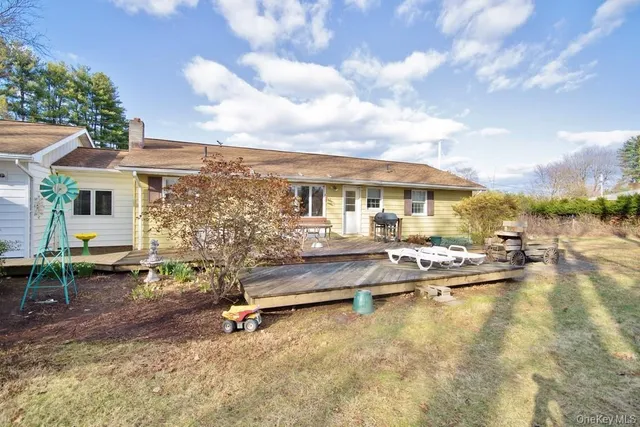 a view of swimming pool with outdoor seating and a garden