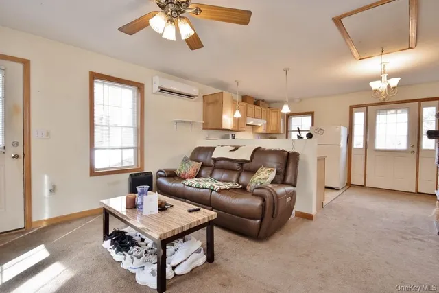 a living room with furniture and a chandelier