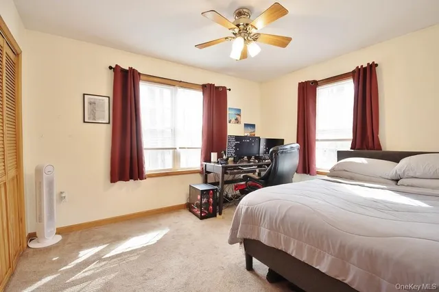 a bedroom with a bed couch and a window