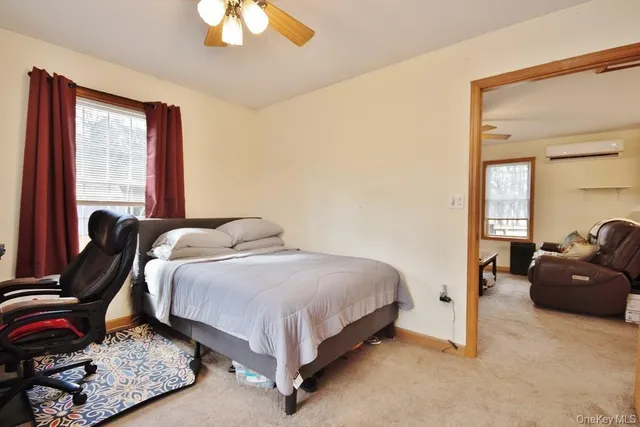 a bedroom with a bed and window