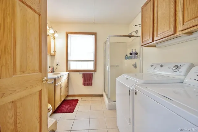 a bathroom with a sink a vanity and a shower