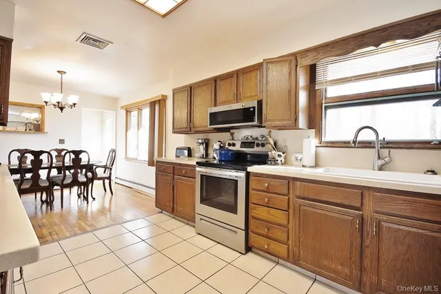 a kitchen with a sink cabinets and window