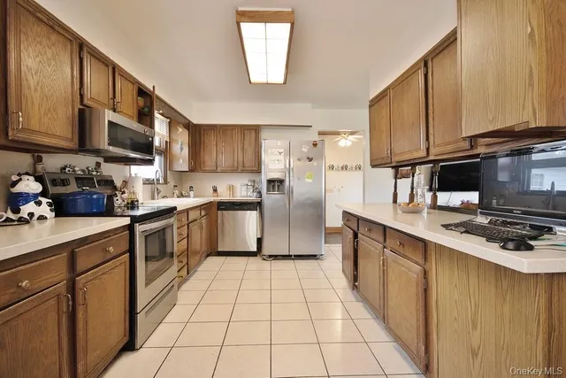 a kitchen with stainless steel appliances granite countertop a stove top oven a sink dishwasher and cabinets with wooden floor