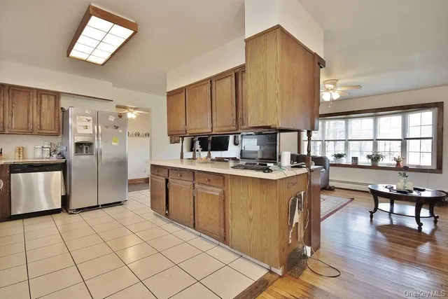 a kitchen with stainless steel appliances a refrigerator sink and cabinets