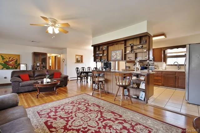 a living room with furniture a rug and a chandelier