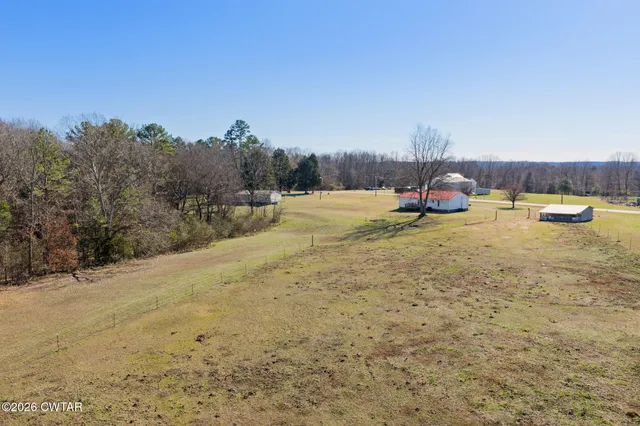 a view of a lake with a car parked on the road