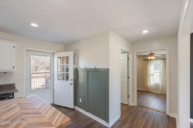 a view of a room with wooden floor and windows