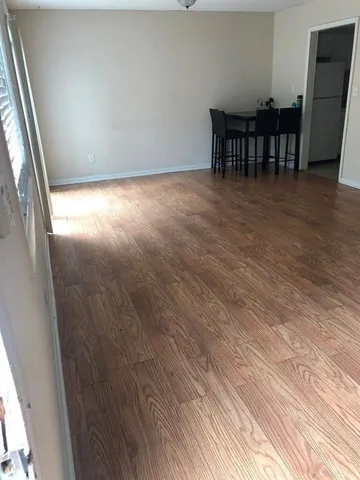 a view of a room with wooden floor
