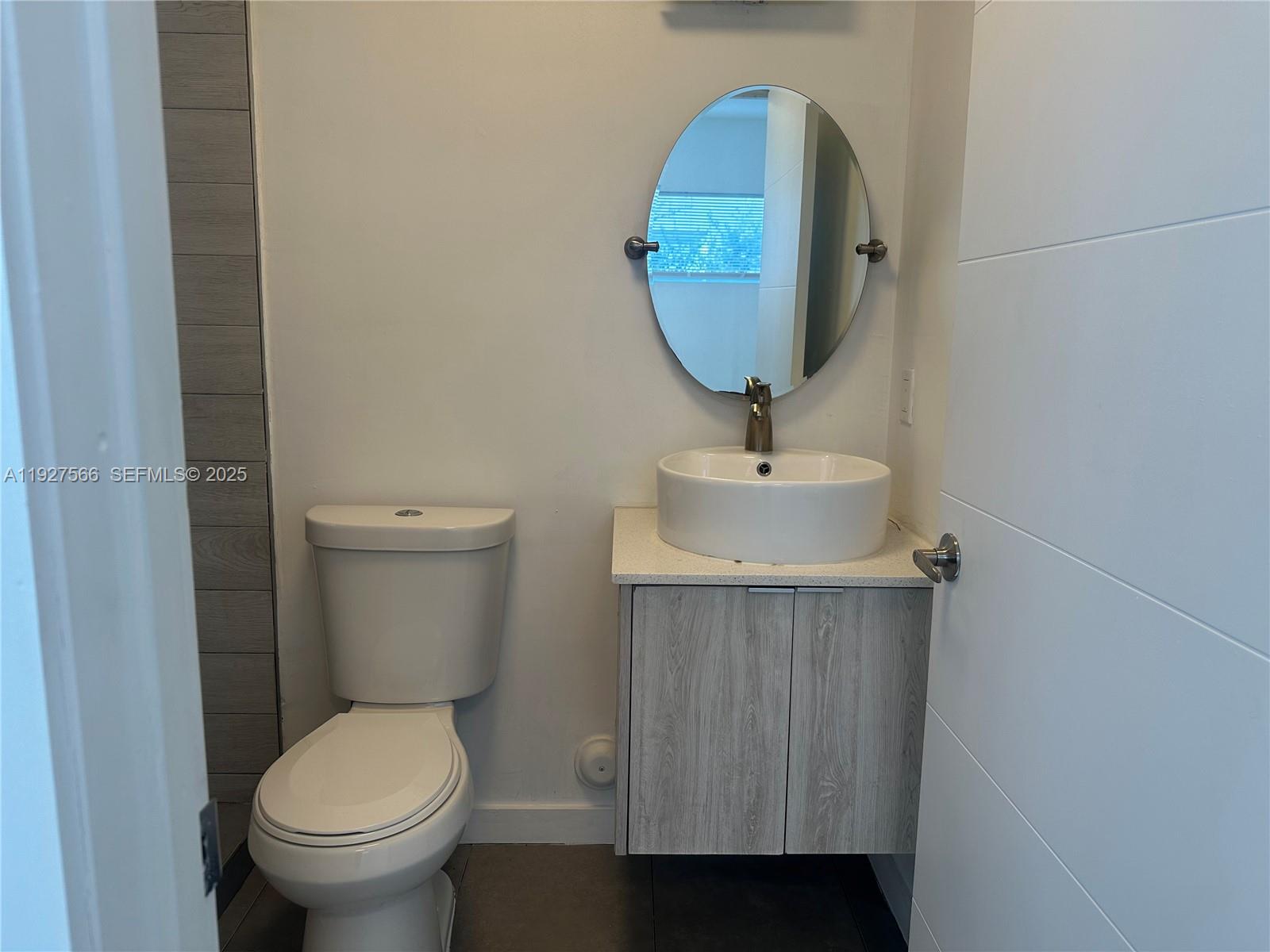 2206 Simms Street, Unit 2206 Hollywood, FL 33020 - Photo 18 of 23 a bathroom with a toilet sink and mirror