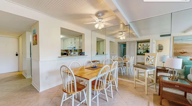 a view of a dining room with furniture and a chandelier