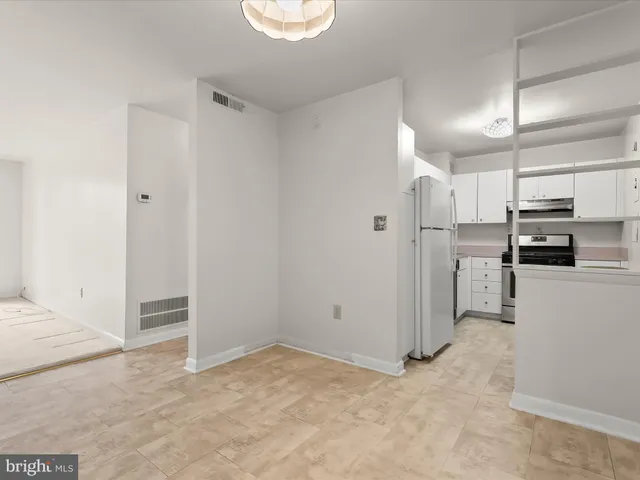 a view of a kitchen with a sink and a refrigerator