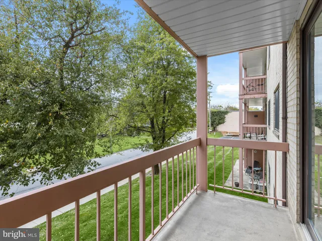 a view of a balcony with wooden floor and fence