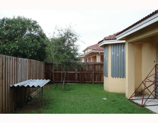 14920 Southwest 21st Terrace Miami, FL 33185 - Photo 2 of 8 a backyard of a house with table and chairs