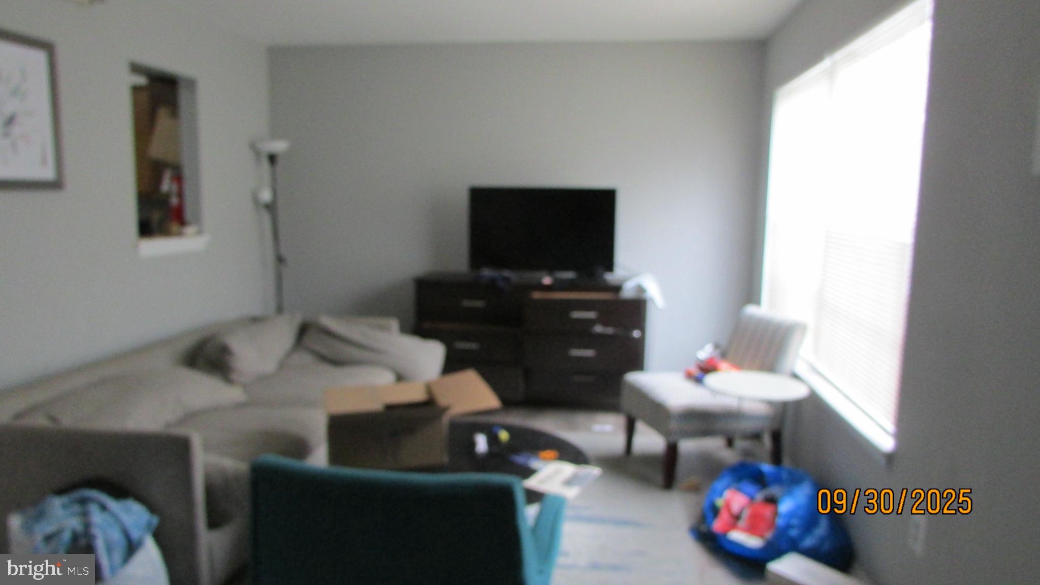 4805 Berwyn House Road, Unit A4805 College Park, MD 20740 - Photo 3 of 17 a living room with furniture and a flat screen tv