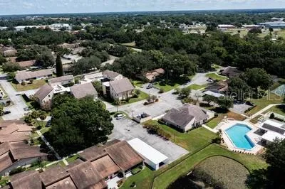 an aerial view of multiple houses with yard