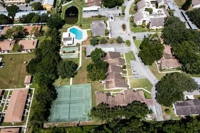 an aerial view of multiple houses with yard