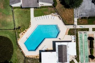 an aerial view of a house with a garden and trees
