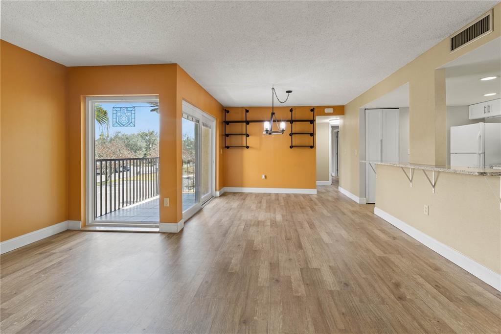 2025 Sylvester Road, Unit N202 Lakeland, FL 33803 - Photo 4 of 29 a view of a big room with wooden floor and windows