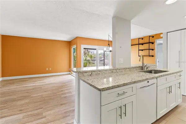 a kitchen with a sink cabinets and a large window