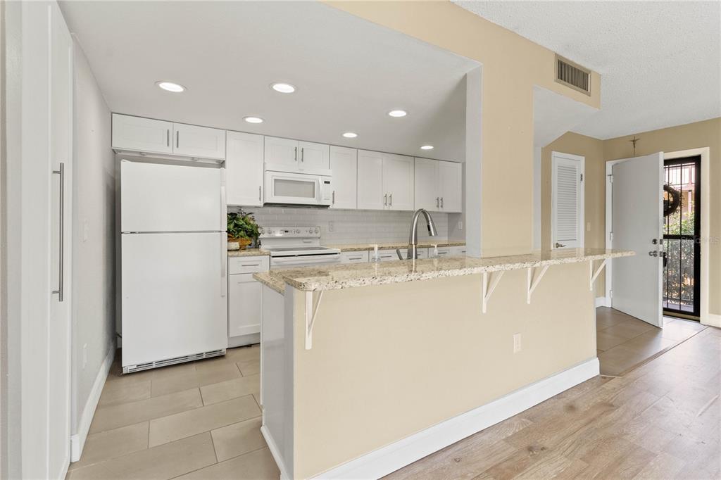 2025 Sylvester Road, Unit N202 Lakeland, FL 33803 - Photo 6 of 29 a view of kitchen with stainless steel appliances granite countertop cabinets and a refrigerator