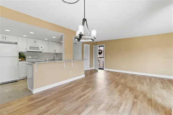 a view of a kitchen with wooden floor